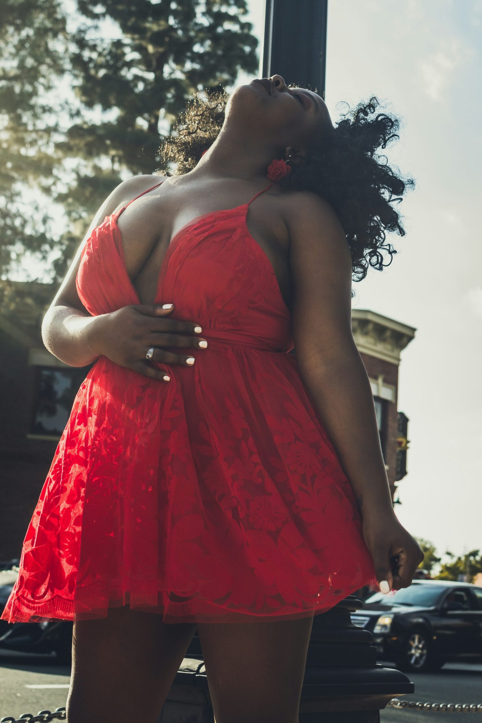 woman in red spaghetti strap dress